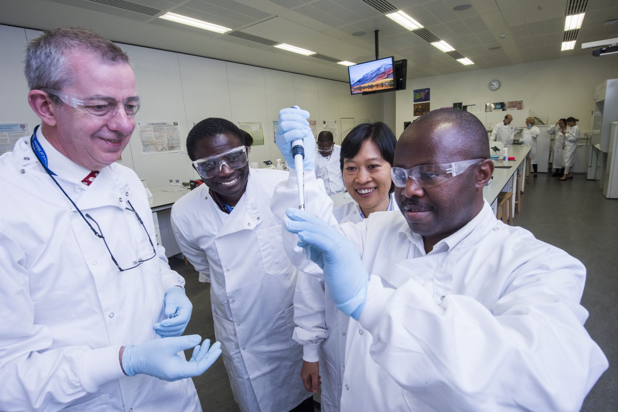Workers at the University of St Andrews International Conference on tuberculosis School of Medicine collaborating in a lab