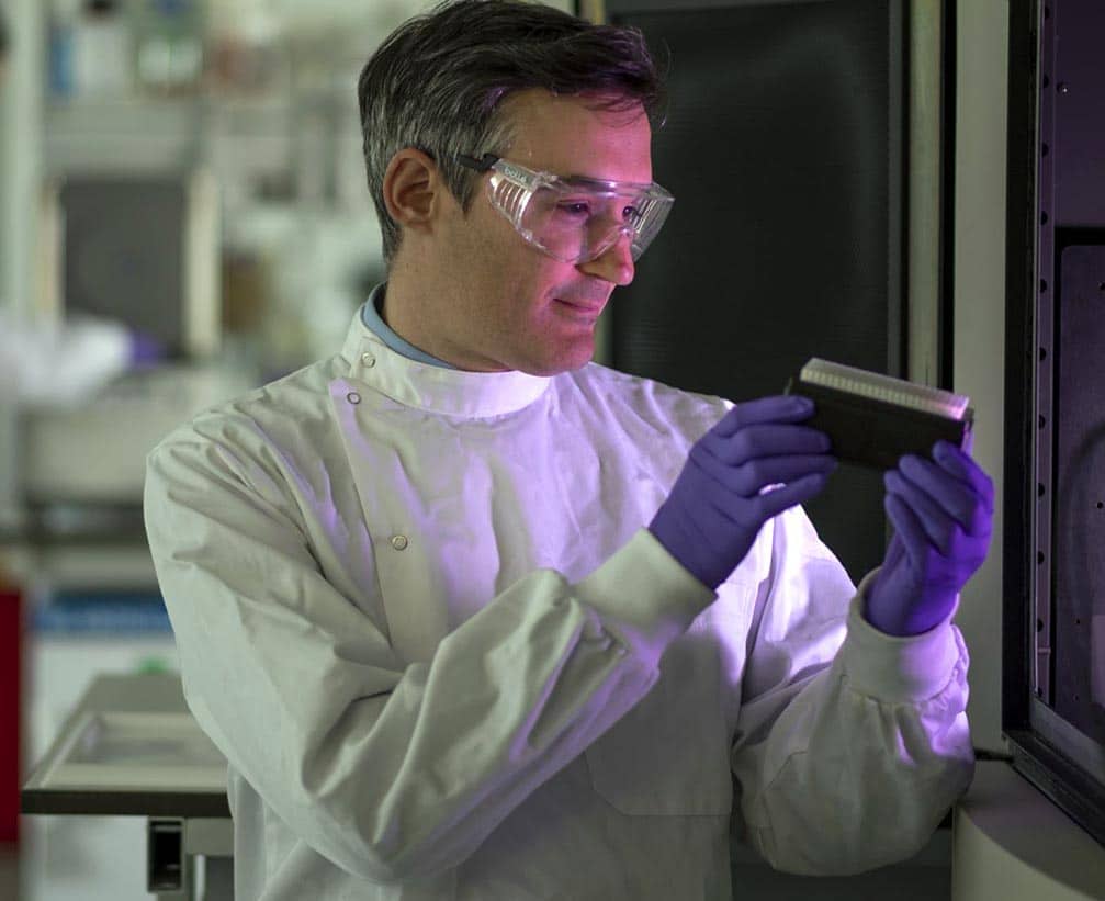 Scient in a lab caring out an experiment