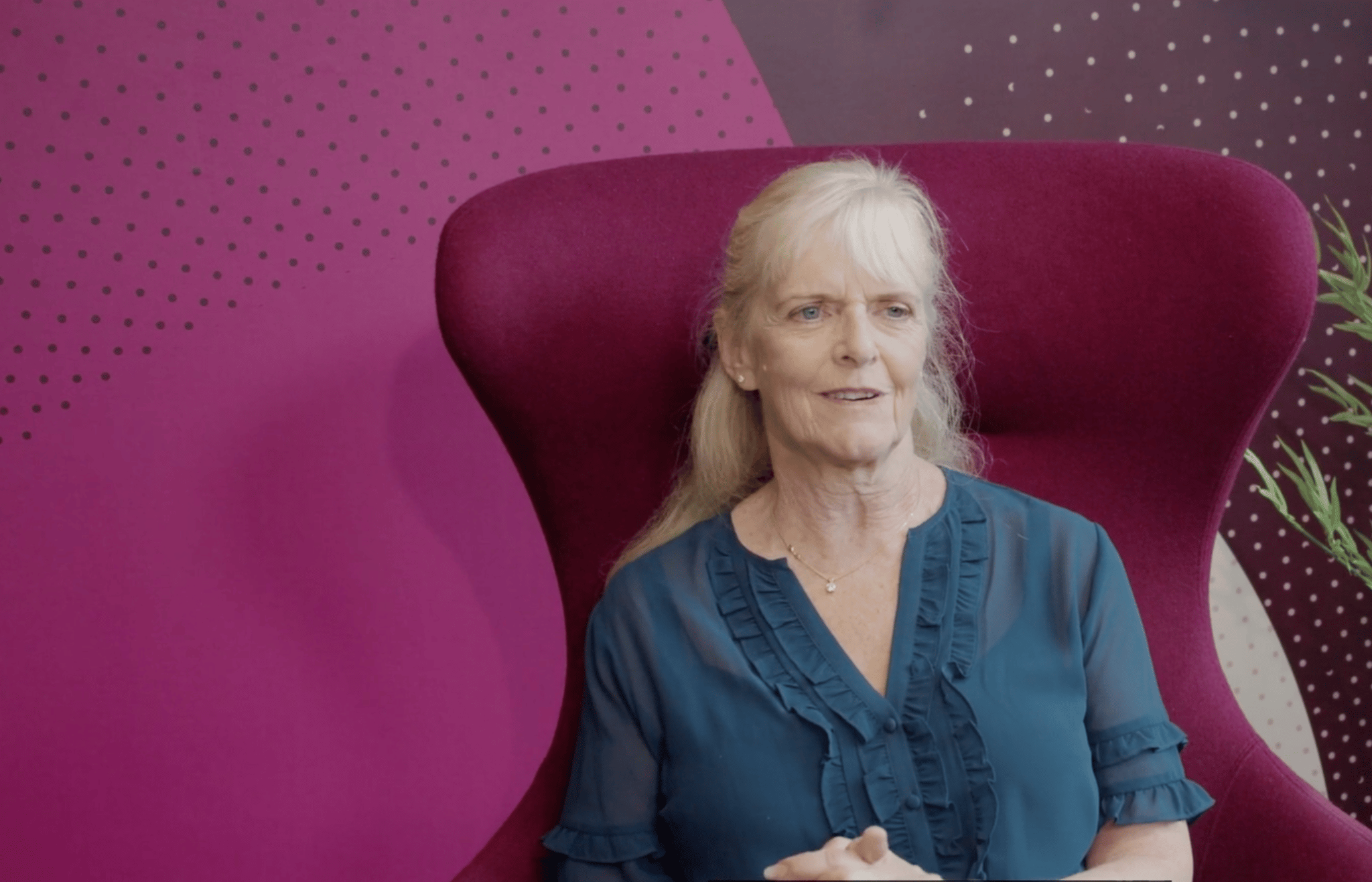 Melanie Lee, CEO, on a pink chair in a pink room