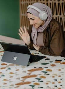 Woman in headscarf talking via an iPad