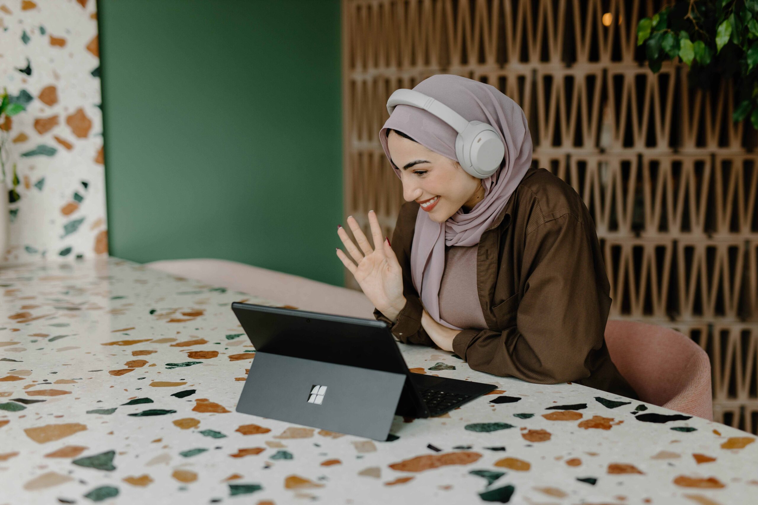 Student on a virtual call, waving