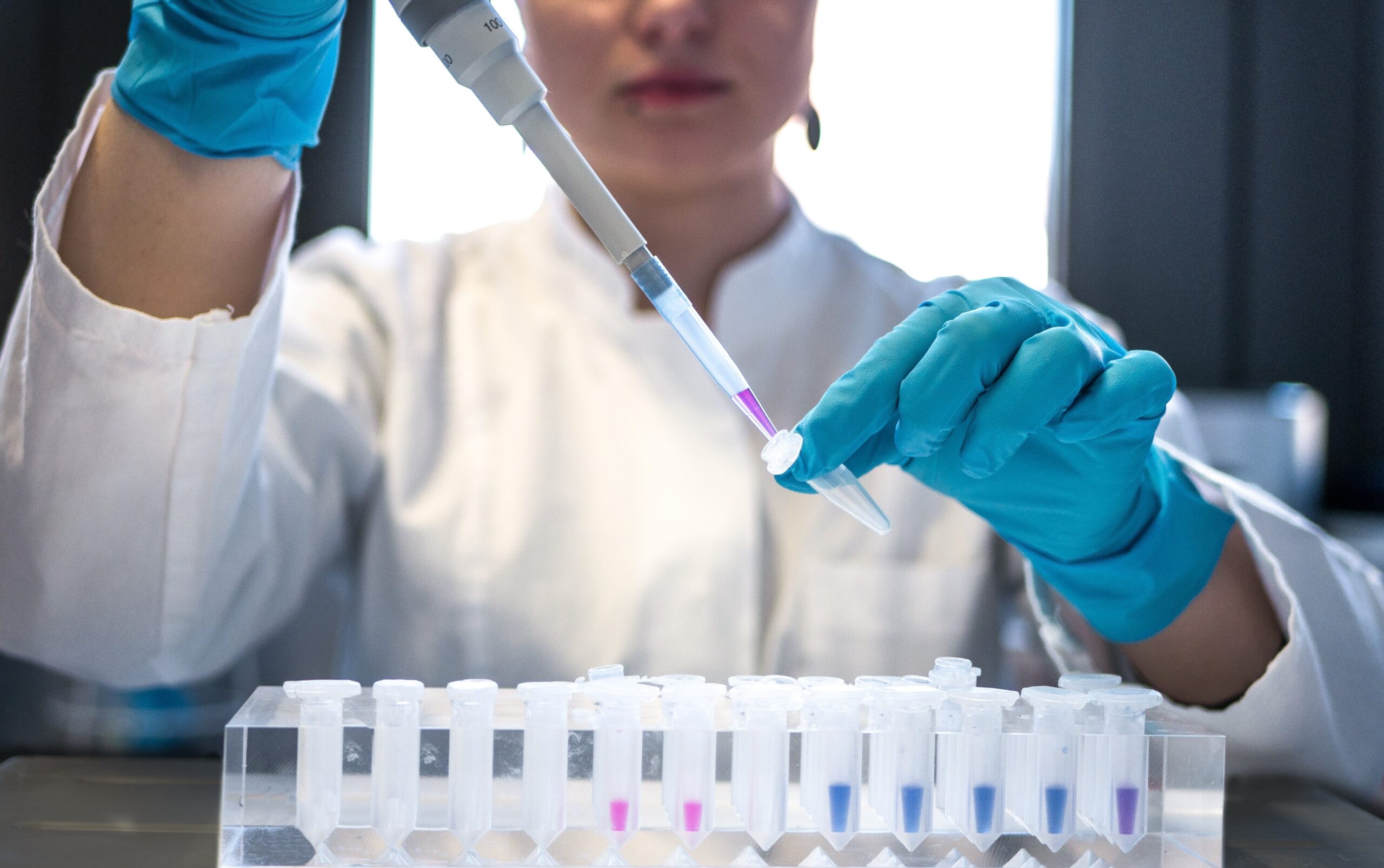 Scientist pipetting in a lab