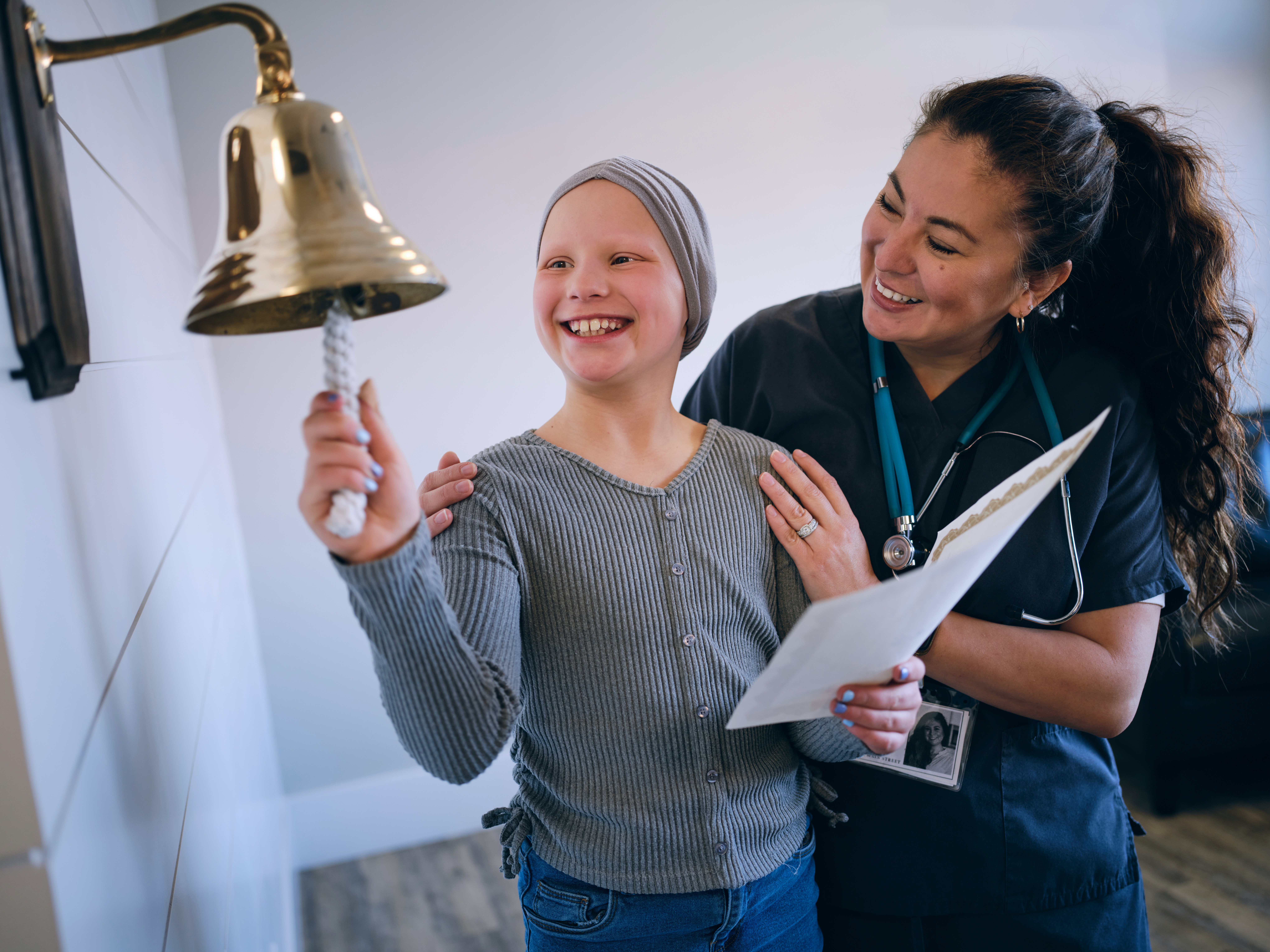 Child ringing bell following cancer treatment