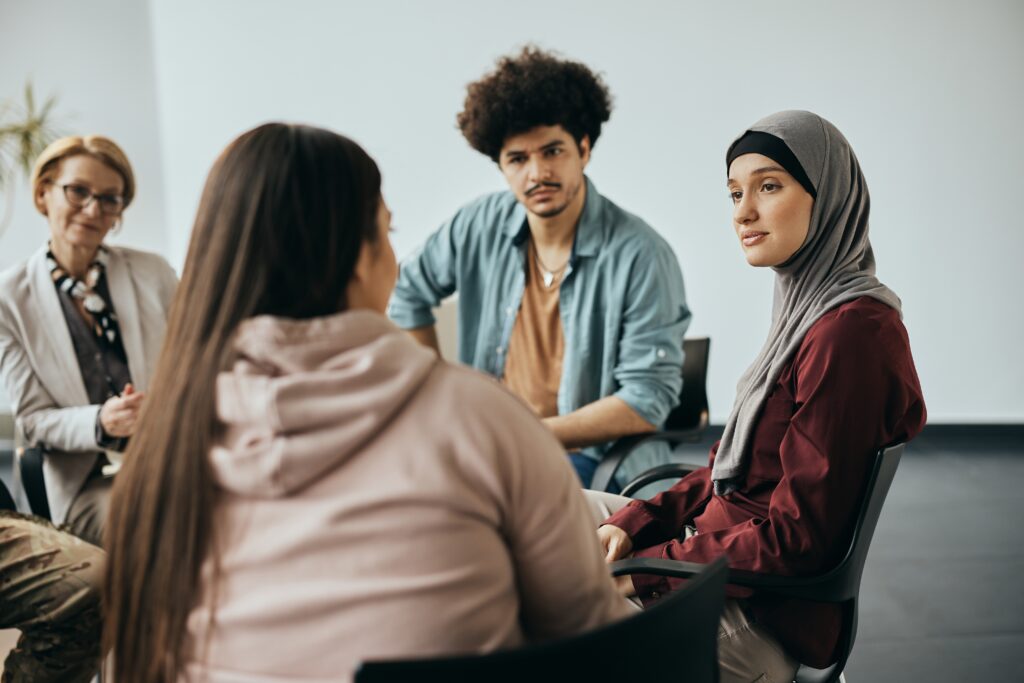 Four people sitting around in a focus group having a discussion