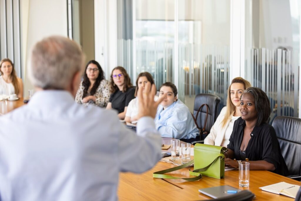 LifeArc fellows sat around a meeting table with a presenter at the front