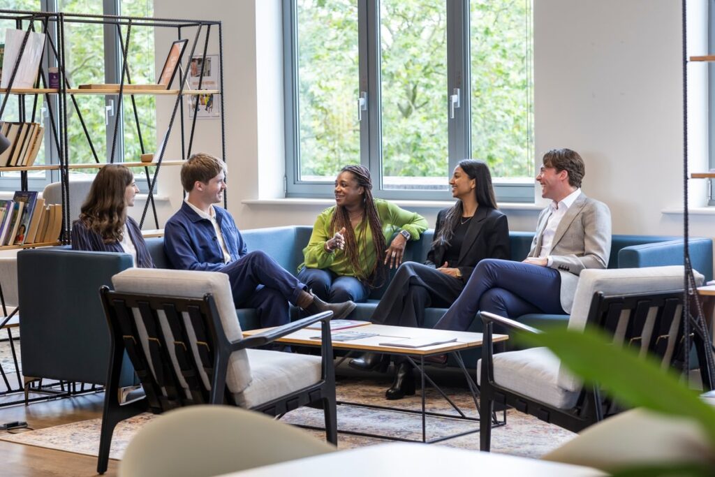 Group of LifeArc Technology Transfer fellows sat on a sofa chatting 