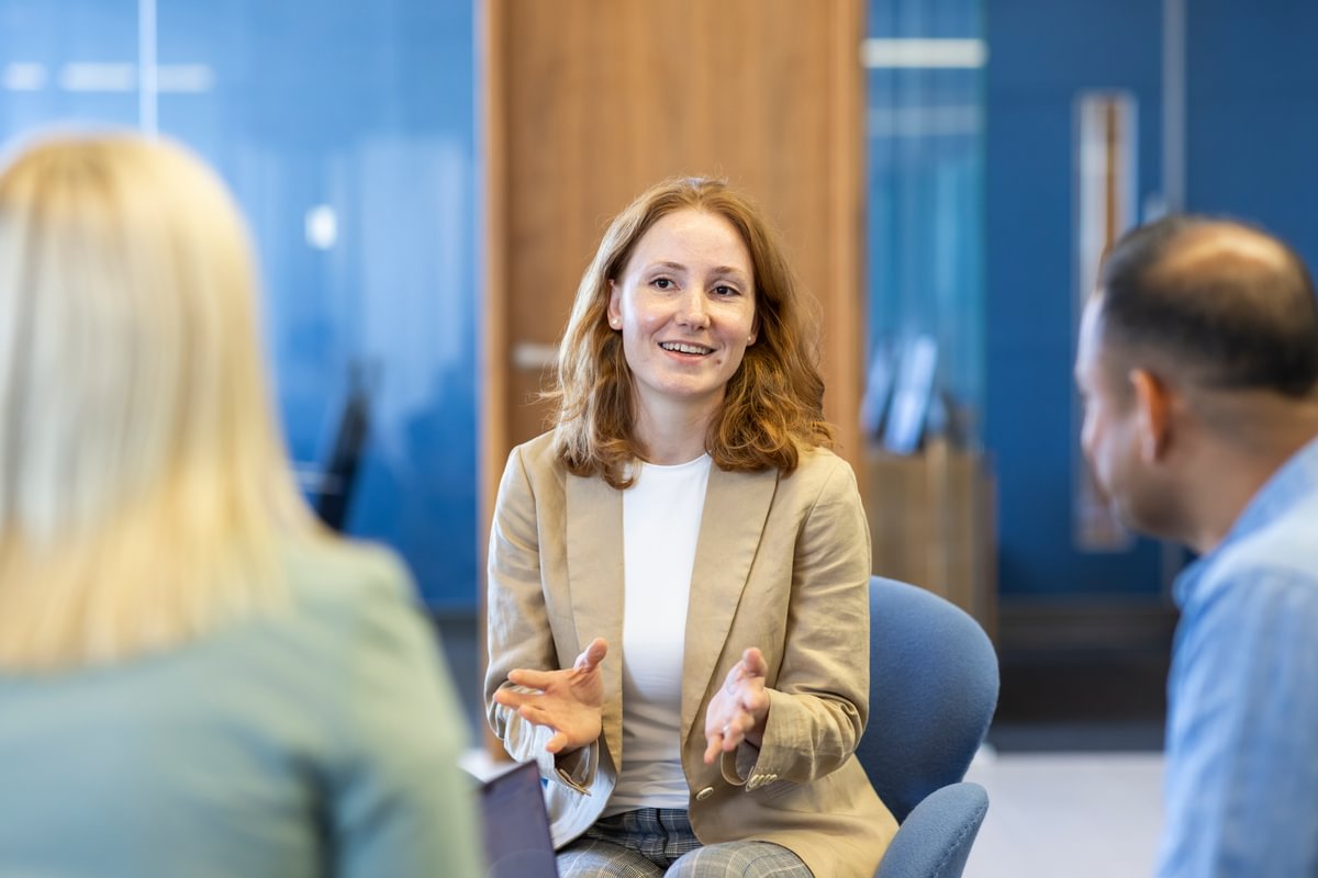 Female LifeArc fellow sat talking to two other fellows