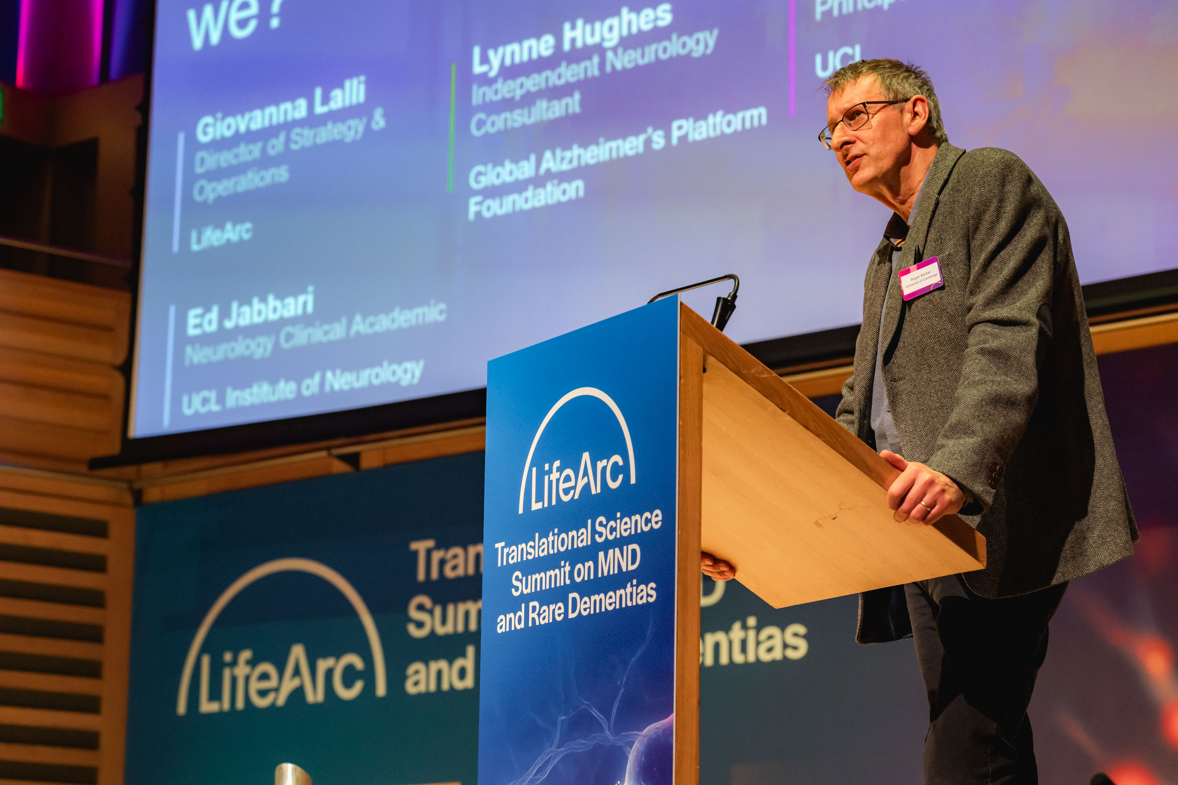 Roger Barker presenting on stage at the LifeArc Translational Science Summit for MND and Rare Dementias