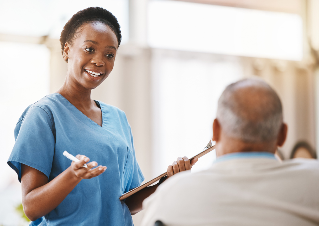 Female healthcare professional talking to a patient.