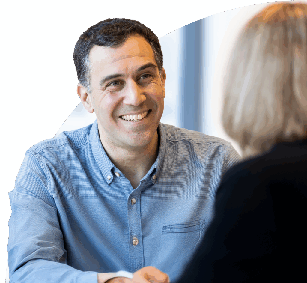 Male LifeArc colleague smiling and chatting with female colleague