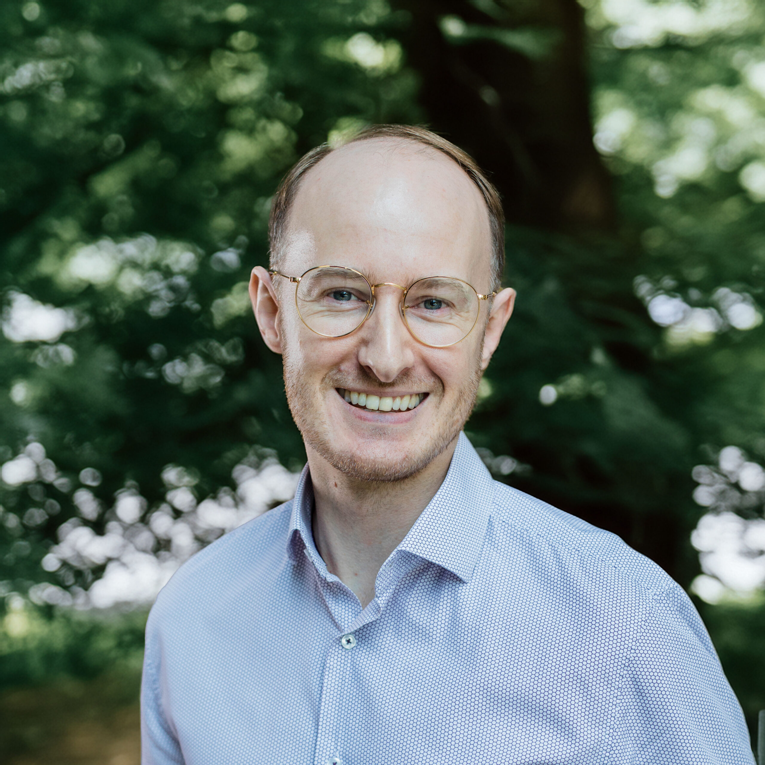 Headshot of Adam Walker smiling at camera.