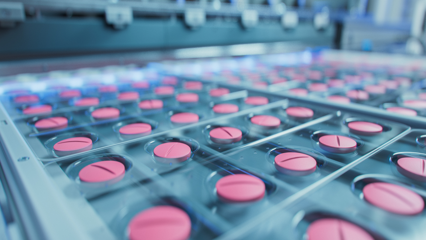 Macro Shot of Pink Pills During Production and Packing Process on Modern Pharmaceutical Factory. Medical Drug Manufacturing.