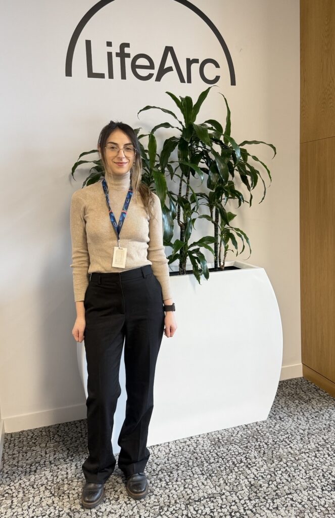 Ylenia in the office with LifeArc logo above 