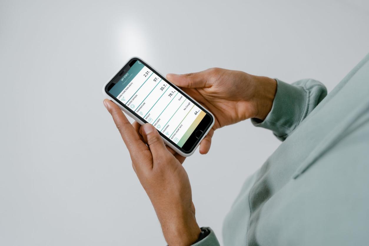 Close up of someone holding a smart phone and looking at home monitoring data 