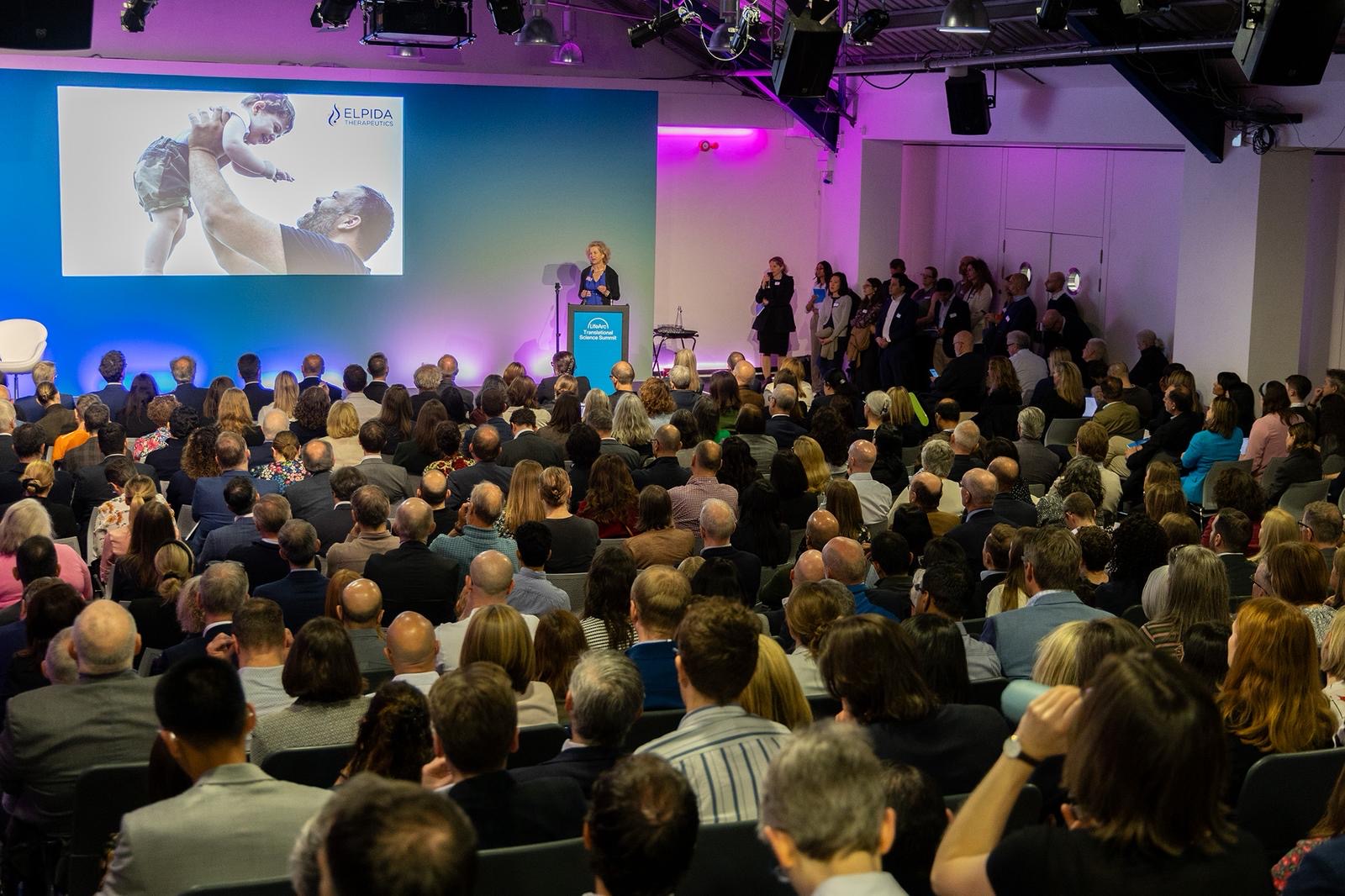 Sam Barrell presenting to a packed conference room