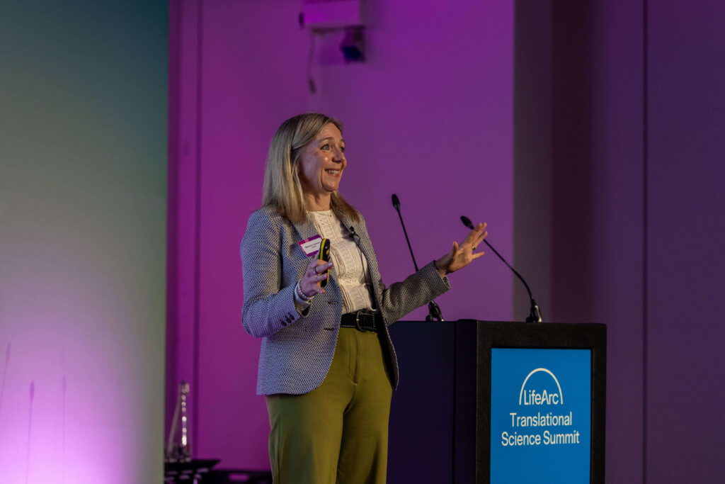 Melanie Ivarsson presenting on stage at the LifeArc Translational Science Summit