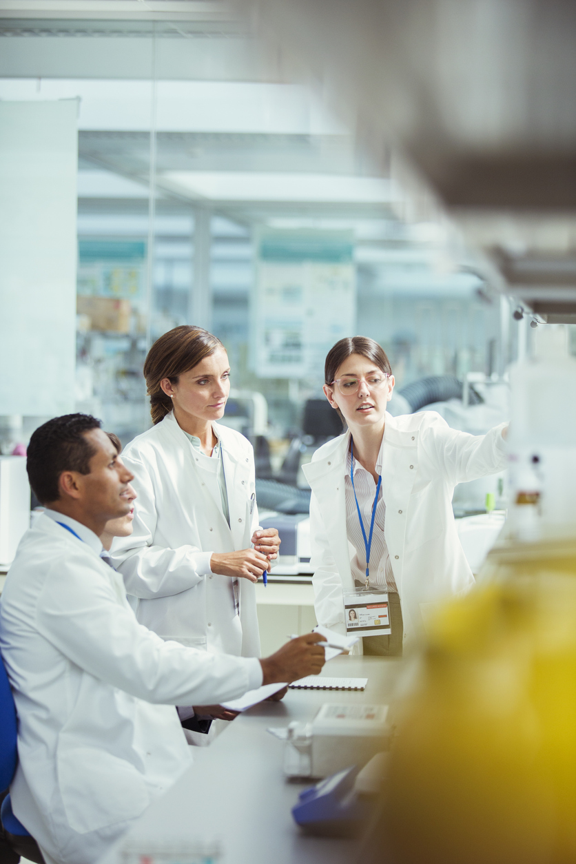 Scientists working and having discussions about working in laboratory